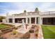 Elegant backyard with a two-story home, balcony, statue, and garden at 3306 E Jaeger Cir, Mesa, AZ 85213