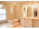 Bright bathroom with marble floors, a soaking tub, and a custom vanity at 3306 E Jaeger Cir, Mesa, AZ 85213