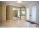 Spacious bedroom featuring tiled floors, mirrored closet doors, and a built-in wet bar area at 3306 E Jaeger Cir, Mesa, AZ 85213