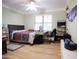Comfortable bedroom with light green walls, ceiling fan, and bright window at 3306 E Jaeger Cir, Mesa, AZ 85213