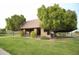 Open-air community pavilion featuring picnic tables, surrounded by lush greenery and mature trees at 3306 E Jaeger Cir, Mesa, AZ 85213