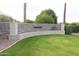 A stone community sign sits on a lush green lawn with vibrant flowers and mature landscaping at 3306 E Jaeger Cir, Mesa, AZ 85213