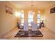 Bright dining room features a glass table and chandelier, offering a perfect space for entertaining guests at 3306 E Jaeger Cir, Mesa, AZ 85213