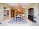 Open dining room with elegant chandelier that connects to other rooms at 3306 E Jaeger Cir, Mesa, AZ 85213