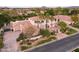 Aerial view features a two-story home with a red tile roof, palm trees, and manicured landscaping at 3306 E Jaeger Cir, Mesa, AZ 85213