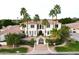 An aerial view of a two-story home with palm trees, tiled roof, iron gate, and lush landscaping at 3306 E Jaeger Cir, Mesa, AZ 85213