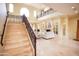 Grand staircase, fireplace, and chandelier combine to create a welcoming foyer in this luxurious home at 3306 E Jaeger Cir, Mesa, AZ 85213