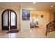 Inviting home foyer showcases a beautiful front door, waterfall artwork, and adjacent dining room at 3306 E Jaeger Cir, Mesa, AZ 85213