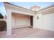 Covered arched front entrance with pavers and desert landscaping on an updated desert home at 3306 E Jaeger Cir, Mesa, AZ 85213