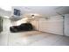 Spacious three car garage with car, storage and lighting perfect for homeowners with cars at 3306 E Jaeger Cir, Mesa, AZ 85213