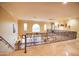 Upstairs hallway with elegant iron railings and neutral walls at 3306 E Jaeger Cir, Mesa, AZ 85213