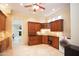 Laundry room features cherry wood cabinets, a utility sink, and a front-load dryer at 3306 E Jaeger Cir, Mesa, AZ 85213