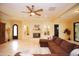 Cozy living room featuring a fireplace, marble floors, and plush sectional sofa at 3306 E Jaeger Cir, Mesa, AZ 85213