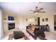 Comfortable living room has tile floors, a fireplace, and a decorative ceiling fan at 3306 E Jaeger Cir, Mesa, AZ 85213
