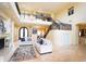 Spacious living room with a fireplace, staircase, chandelier, and plenty of natural light at 3306 E Jaeger Cir, Mesa, AZ 85213