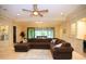 Spacious living room with marble flooring, large sectional, and open layout leading to outdoor area at 3306 E Jaeger Cir, Mesa, AZ 85213