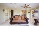 Large living room with tile floors, a ceiling fan, and access to other rooms at 3306 E Jaeger Cir, Mesa, AZ 85213