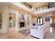 Elegant living room featuring built-in cabinets, fireplace, chandelier, and travertine flooring at 3306 E Jaeger Cir, Mesa, AZ 85213