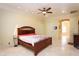 Large main bedroom with travertine floors and ensuite bathroom access at 3306 E Jaeger Cir, Mesa, AZ 85213
