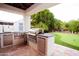 Outdoor kitchen and putting green in a meticulously landscaped backyard at 3306 E Jaeger Cir, Mesa, AZ 85213