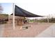 Community playground under shade features play structures for children, fostering recreation and community at 3306 E Jaeger Cir, Mesa, AZ 85213