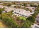 Aerial view showcases the home's backyard with putting green, citrus trees, and covered patio at 3306 E Jaeger Cir, Mesa, AZ 85213