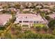 Aerial view features the home's backyard with covered patio, putting green, and citrus trees at 3306 E Jaeger Cir, Mesa, AZ 85213