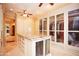 Large walk-in closet with ample storage, a granite island, and glass-front cabinets at 3306 E Jaeger Cir, Mesa, AZ 85213