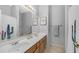 Bright bathroom with a double sink vanity, large mirror, and light wood cabinets, offering ample counter space at 3411 S Vine St, Chandler, AZ 85248