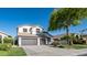 A two-story home with a three car garage and a well maintained lawn and landscape at 3411 S Vine St, Chandler, AZ 85248