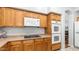 Well-equipped kitchen featuring wood cabinets, an electric cooktop, and modern, built-in appliances at 3411 S Vine St, Chandler, AZ 85248