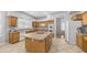 Well-lit kitchen features a central island, white appliances and ample cabinet space at 3411 S Vine St, Chandler, AZ 85248