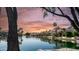 Picturesque waterfront view of homes along a tranquil lake at sunset at 3411 S Vine St, Chandler, AZ 85248