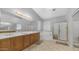 Well-lit primary bathroom featuring double sinks, a soaking tub, and a glass-enclosed shower at 3411 S Vine St, Chandler, AZ 85248
