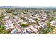 Expansive aerial view of a suburban neighborhood featuring homes with pools, green lawns, and mature trees at 3912 E Rockwood Dr, Phoenix, AZ 85050