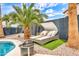 Relaxing backyard oasis with a lounge area, a fire pit, and beautiful palm trees, perfect for outdoor enjoyment at 3912 E Rockwood Dr, Phoenix, AZ 85050