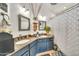 The bathroom boasts double sinks, granite countertops, stylish mirrors, and a shower at 3912 E Rockwood Dr, Phoenix, AZ 85050