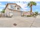Front elevation of home, showcasing desert landscaping, a two-car garage, and a well-maintained lawn at 3912 E Rockwood Dr, Phoenix, AZ 85050