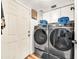Well-lit laundry room with modern Samsung washer and dryer and white cabinets for ample storage at 3912 E Rockwood Dr, Phoenix, AZ 85050