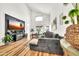 Bright living room with high ceilings, modern furniture, wood flooring, and a large entertainment center at 3912 E Rockwood Dr, Phoenix, AZ 85050