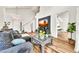 Comfortable living room with wood floors, stylish furnishings, a decorative coffee table, and great natural light at 3912 E Rockwood Dr, Phoenix, AZ 85050