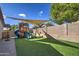 Backyard featuring a play structure on turf with a shade cover, and a basketball hoop at 4350 E Abraham Ln, Phoenix, AZ 85050