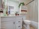 Cozy bathroom with vanity cabinet, mirrored wall cabinet and shower with curtain at 4350 E Abraham Ln, Phoenix, AZ 85050