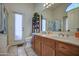 Bright bathroom featuring double sinks, wooden cabinets, and a glass-enclosed shower for a spa-like experience at 4350 E Abraham Ln, Phoenix, AZ 85050