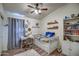 A cozy bedroom with a fan, desk, storage, and decorative wall art at 4350 E Abraham Ln, Phoenix, AZ 85050
