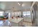 Stylish kitchen with island, white cabinets, stainless steel appliances, and modern fixtures at 4350 E Abraham Ln, Phoenix, AZ 85050