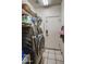 A laundry room with washer and dryer hookups, storage shelves, and tile floors at 4350 E Abraham Ln, Phoenix, AZ 85050