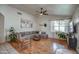 Spacious living room boasts wood floors, a ceiling fan, and a large sectional sofa for comfortable seating at 4350 E Abraham Ln, Phoenix, AZ 85050