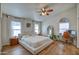 Serene bedroom with hardwood floors, large windows, and an ensuite workspace with a desk and chair at 4350 E Abraham Ln, Phoenix, AZ 85050