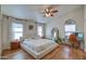 Serene bedroom with hardwood floors, large windows, and an ensuite workspace with a desk and chair at 4350 E Abraham Ln, Phoenix, AZ 85050